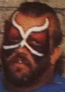 Road Warrior Animal with white, black and red face paint, with devil horns in a design somewhat like a butterfly.